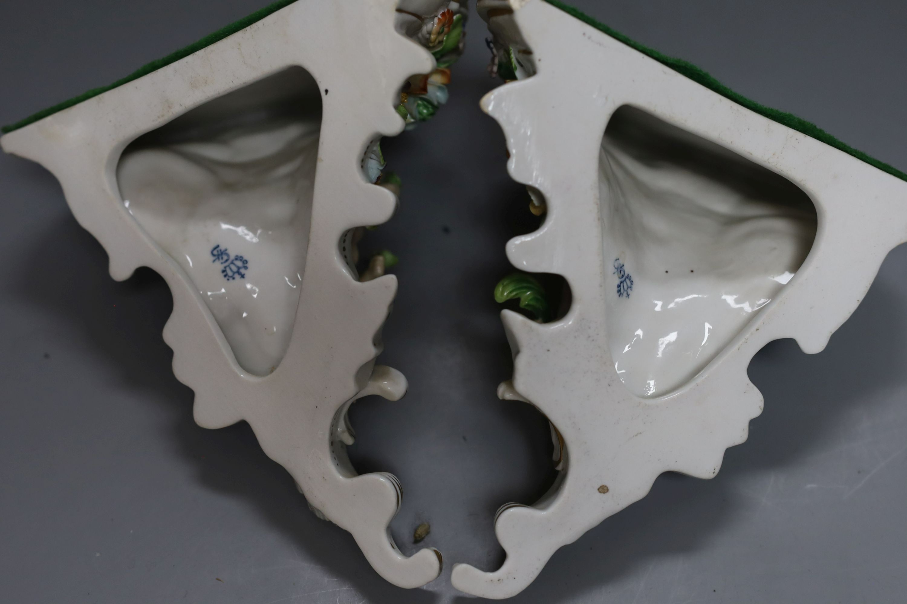 A pair of Sitzendorf wall brackets, 16cm tall, together with a Sitzendorf figure (3)